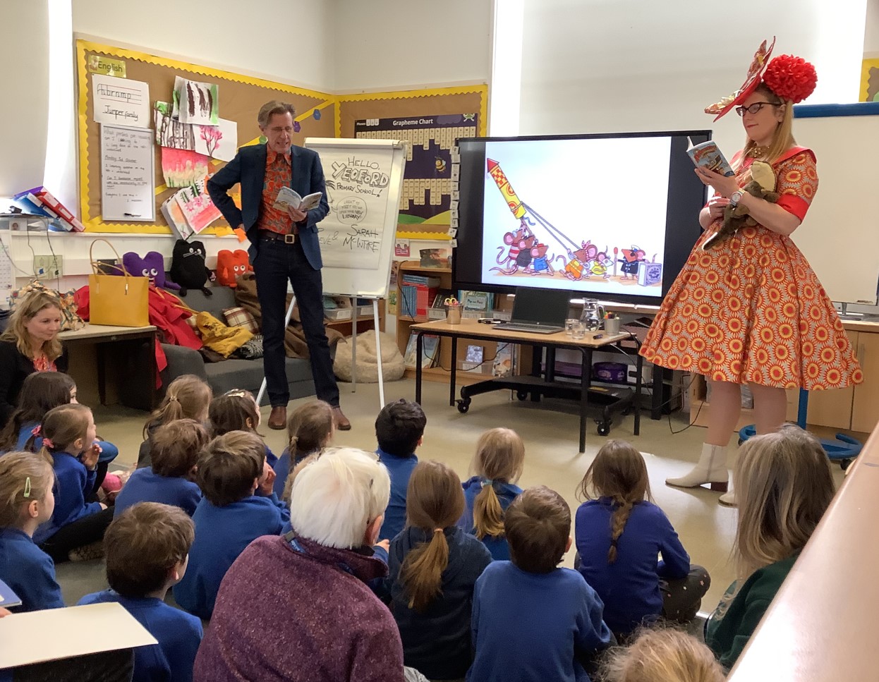 Class of school children listen to authors