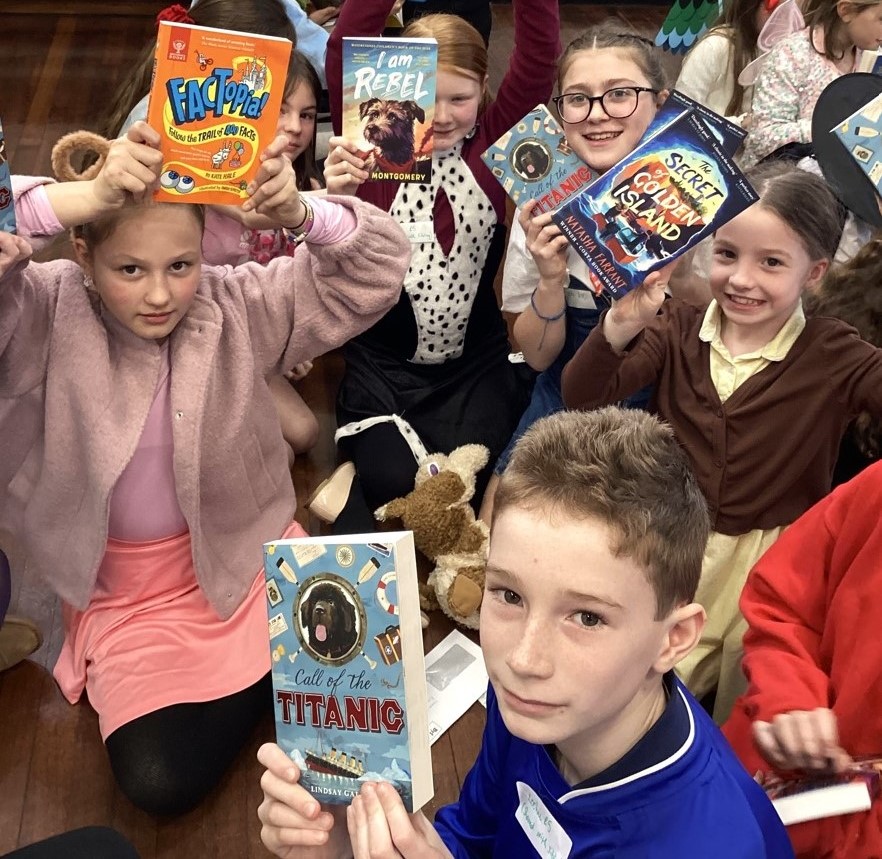 Children holding up books